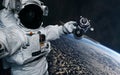 The astronaut holds in his hand a space station in orbit of the Earth. Solar system