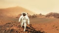 Astronaut man walks in the desert with mountains in Mars.