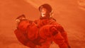 An astronaut on Mars carries a wounded astronaut during a violent dust storm. The man was created using 3D computer