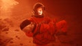 An astronaut on Mars carries a wounded astronaut during a violent dust storm. The man was created using 3D computer