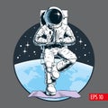 Astronaut meditating in tree pose, standing in vrksasana posture on yoga mat. Outer space, planet and stars on the background. Com