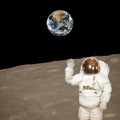 Astronaut on the moon. Blue fascinating earth on the background. Elements of this image furnished by NASA