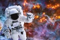 Astronaut near exploding planet with earth in space