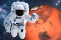 Astronaut near Mars planet in space Closeup