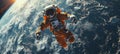 Astronaut in orange space suit performing spacewalk in open space. Planet Earth in the background. Royalty Free Stock Photo