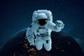 Astronaut in outer space on the background of the planet Earth. Spaceman levitates. Travel concept. Royalty Free Stock Photo