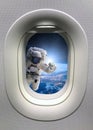 Astronaut in outer space from porthole. Elements of this image furnished by NASA Royalty Free Stock Photo