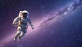 Astronaut in outer space. Science fiction. Spaceman in spacesuit floating against starry sky.