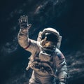 Astronaut in outer space waving his hand to the camera. Royalty Free Stock Photo