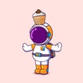 The astronaut is playing with small sweet cake on the top of his head