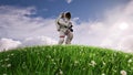 Astronaut running through a green meadow of flowers against a cloud background 3d Royalty Free Stock Photo