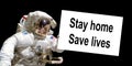 Astronaut in space holding a board with the message Stay home, save lives