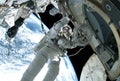 The astronaut in a space suit, in an outer space, is engaged in repair of station. Elements of this image were furnished by NASA Royalty Free Stock Photo