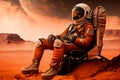 An astronaut, surrounded by the desolate Martian landscape, sits contemplatively in a chair Royalty Free Stock Photo