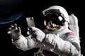 Astronaut using smartphone in outer space