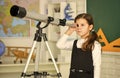 Astronaut Using Telescope. School astronomy lesson. Exploring space of new galaxies. School girl looking through