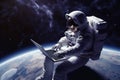 An astronaut works on his laptop in space.