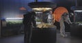 Astronauts and robot examining plant incubator