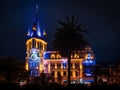 Astronomical clock in Batumi Tower in Europe Square, night view of luxurious building of the former National Bank of Georgi