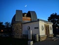 Astronomical observatory. Telescope in the building. Crescent Moon in the blue sky