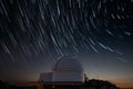 Astronomical observatory under star trails sky at night Royalty Free Stock Photo