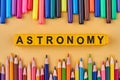 Astronomy inscription made from plastic cubes in frame from colored pencils and markers. Royalty Free Stock Photo