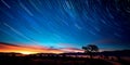 astrophotography with long exposure to capture star trails over a captivating landscape . Generative AI