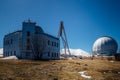 Astrophysical observatory in mountains on blue sky background at sunny day