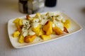 Asturian style roasted potato chips with melted blue cheese cabrales from Las Arenas village, Asturias, Spain Royalty Free Stock Photo