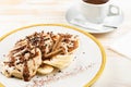 asty dessert made with pancakes, chocolate syrup and cup of coffee on white background. Breakfast concept