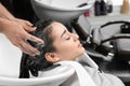 AStylist washing client`s hair at sink in salon Royalty Free Stock Photo