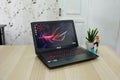 The asus rog laptop is black with the asus logo on
