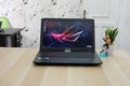 The asus rog laptop is black with the asus logo on