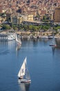 12.11.2018 Aswan, Egypt, A boat felucca sailing along a river Nile on a sunny day against Royalty Free Stock Photo