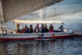 Aswan, Egypt - Dec. 2018: Two Egyptian boys on a paddle-up trying to get tourists attention approaching their boat singing, in the