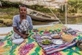 ASWAN, EGYPT: FEB 15, 2019: Crewman of a felucca sail boat at the river Nile with a meal, Egy