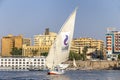 Aswan, Egypt - September 13, 2018: Faluca boat sailing in Nile river at sunset Royalty Free Stock Photo