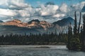 The Athabasca river flows by the Canadian rocky mountains in Alberta, Canada Royalty Free Stock Photo