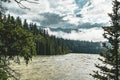 The Athabasca river flows by the Canadian rocky mountains in Alberta, Canada Royalty Free Stock Photo