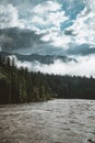 The Athabasca river flows by the Canadian rocky mountains in Alberta, Canada Royalty Free Stock Photo