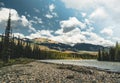 The Athabasca river flows by the Canadian rocky mountains in Alberta, Canada Royalty Free Stock Photo