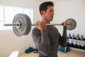 Athelte lifting barbell at gym Royalty Free Stock Photo