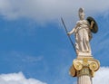 Athena marble statue the ancient Greek goddess of knowledge and wisdom under a blue sky with clouds, some space for text.