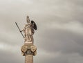 Athena marble statue, the ancient Greek goddess of science and wisdom, isolated on a dark grey sky background.