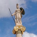 Athena marble statue the ancient greek Olympian goddess of knowledge and wisdom, under blue sky with clouds.