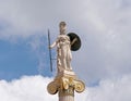 Athena marble statue the ancient greek Olympian goddess of knowledge and wisdom, under blue sky with clouds.