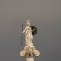 Athena statue, the ancient Greek goddess of science and wisdom, on dark grey sky background