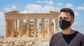 Athens Acropolis, Greece coronavirus days. Young man wearing protective face mask on Parthenon temple and blue sky background Royalty Free Stock Photo