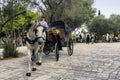 Athens, Attica / Greece - October 21, 2018: Coachman with his horse carriage is waiting for tourists to take them a ride across th Royalty Free Stock Photo