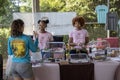 Two African-American women bakers sell their products at an outdoor market. Royalty Free Stock Photo